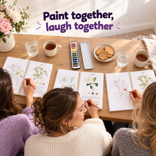 Friends painting their watercolour workbooks together